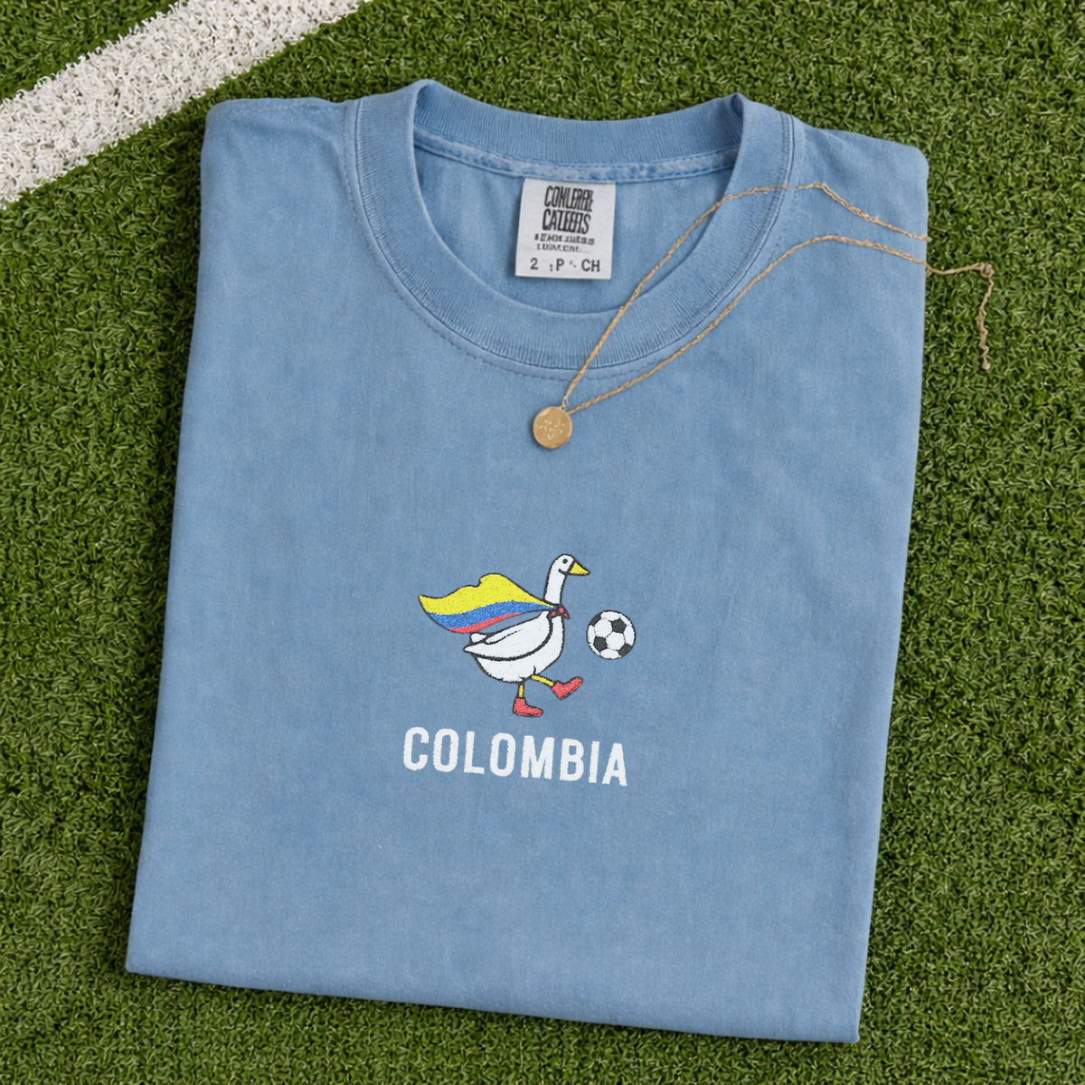 Embroidered Colombia Soccer Goose Shirt – Jean Blue flat lay