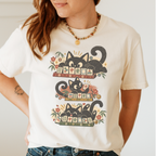 Retro Black Cats Mahjong Shirt in Ivory - worn by a woman, three black cats over a row of mahjong tiles with arched MAHJONG lettering