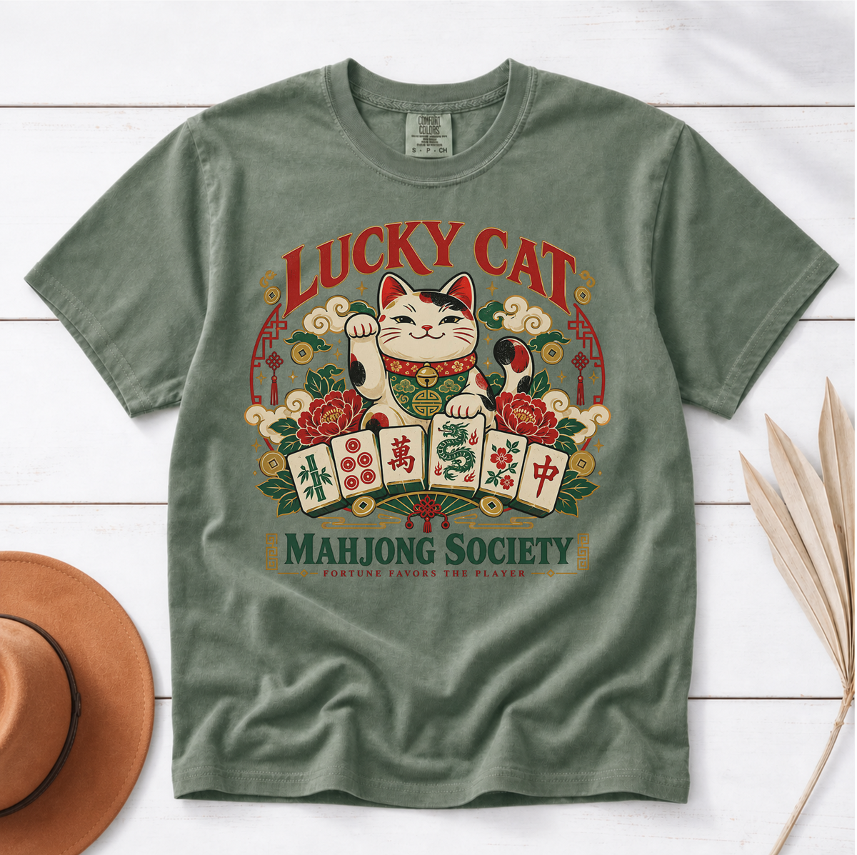 Lucky Cat Mahjong Society t-shirt in Blossom, flat lay on white wood