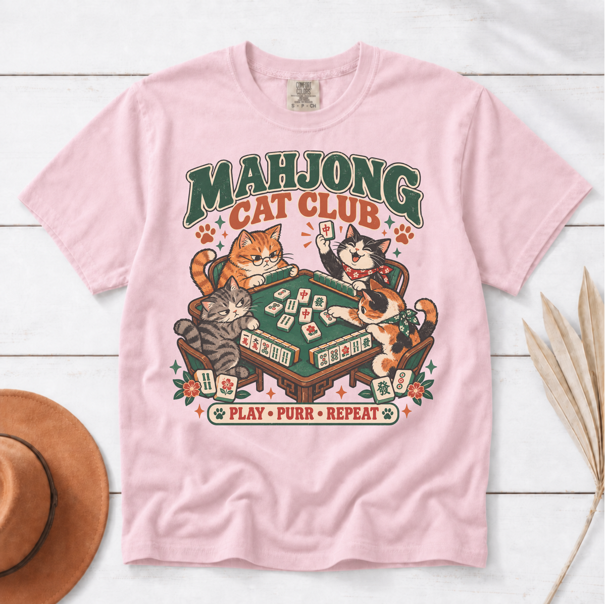 Mahjong Cat Club t-shirt in Ivory, folded mockup on white wood