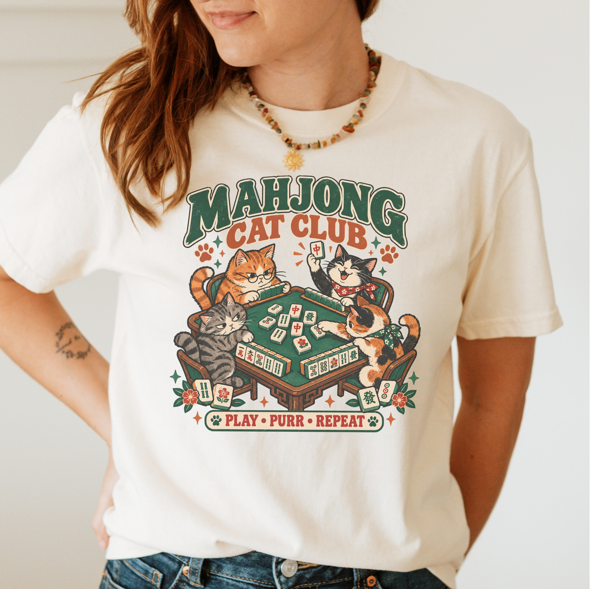 Mahjong Cat Club t-shirt in White, flat lay on white wood