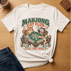 Mahjong Cat Club t-shirt in Ivory, flat lay on white wood