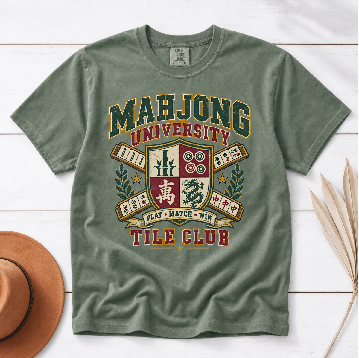 Mahjong University Tile Club t-shirt in Jean Blue, flat lay on white wood