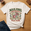 Mahjong University Tile Club t-shirt in Ivory, flat lay on white wood