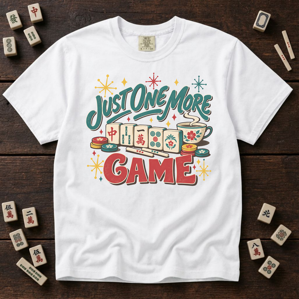 Just One More Game mahjong t-shirt in White, flat lay on white wood