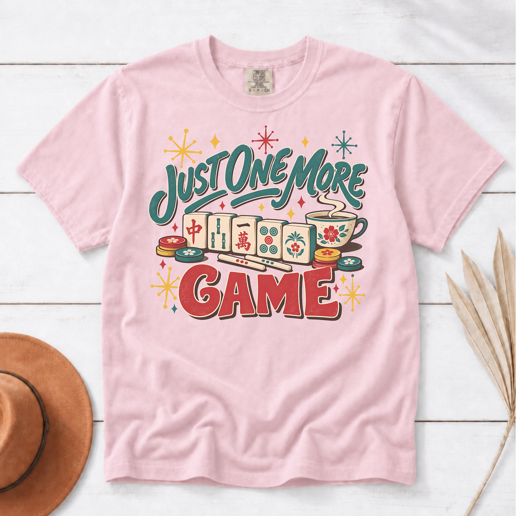 Just One More Game mahjong t-shirt in Ivory, folded mockup on white wood