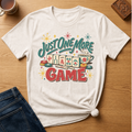 Just One More Game mahjong t-shirt in Ivory, flat lay on white wood
