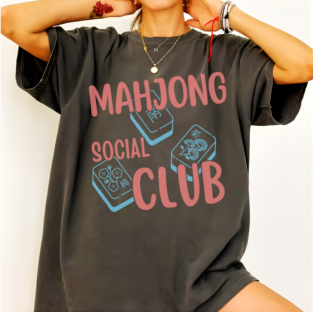 Mahjong Social Club Shirt in Pepper - MAHJONG SOCIAL CLUB typographic tile design on a dark grey Comfort Colors 1717 tee, flat lay