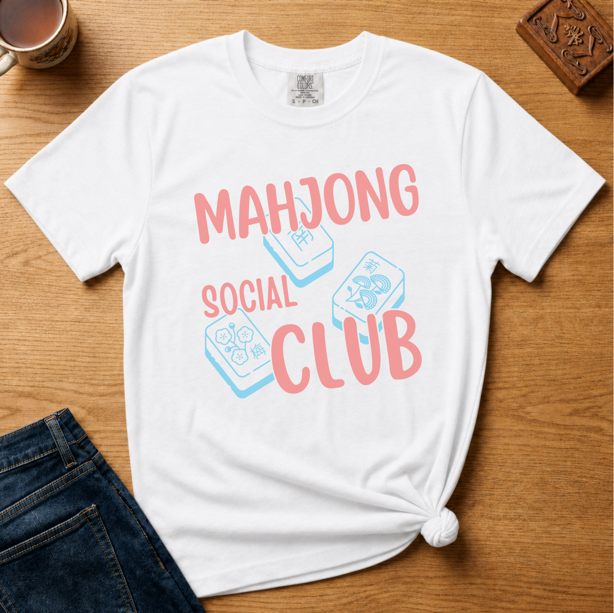 Mahjong Social Club Shirt in White - MAHJONG SOCIAL CLUB typographic tile design on a white Comfort Colors 1717 tee, flat lay