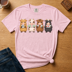 Mahjong Cows Shirt in Ivory - four cartoon cows holding mahjong tiles on an ivory Comfort Colors 1717 tee, flat lay