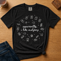 Apparently I Like Mahjong Shirt in Black - hand-lettered script with line-art mahjong tile doodles on a black Comfort Colors 1717 tee, flat lay