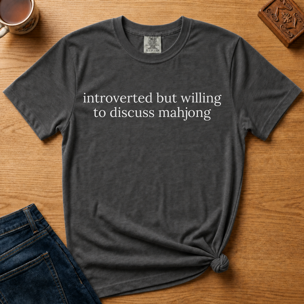 Introverted But Willing To Discuss Mahjong Shirt in Pepper - cream serif text on a dark grey Comfort Colors 1717 tee, flat lay