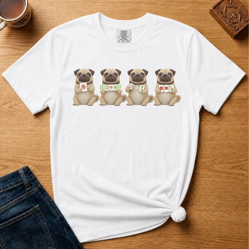 Mahjong Pugs Shirt in Blossom - four cartoon pugs holding mahjong tiles on a pink Comfort Colors 1717 tee, flat lay