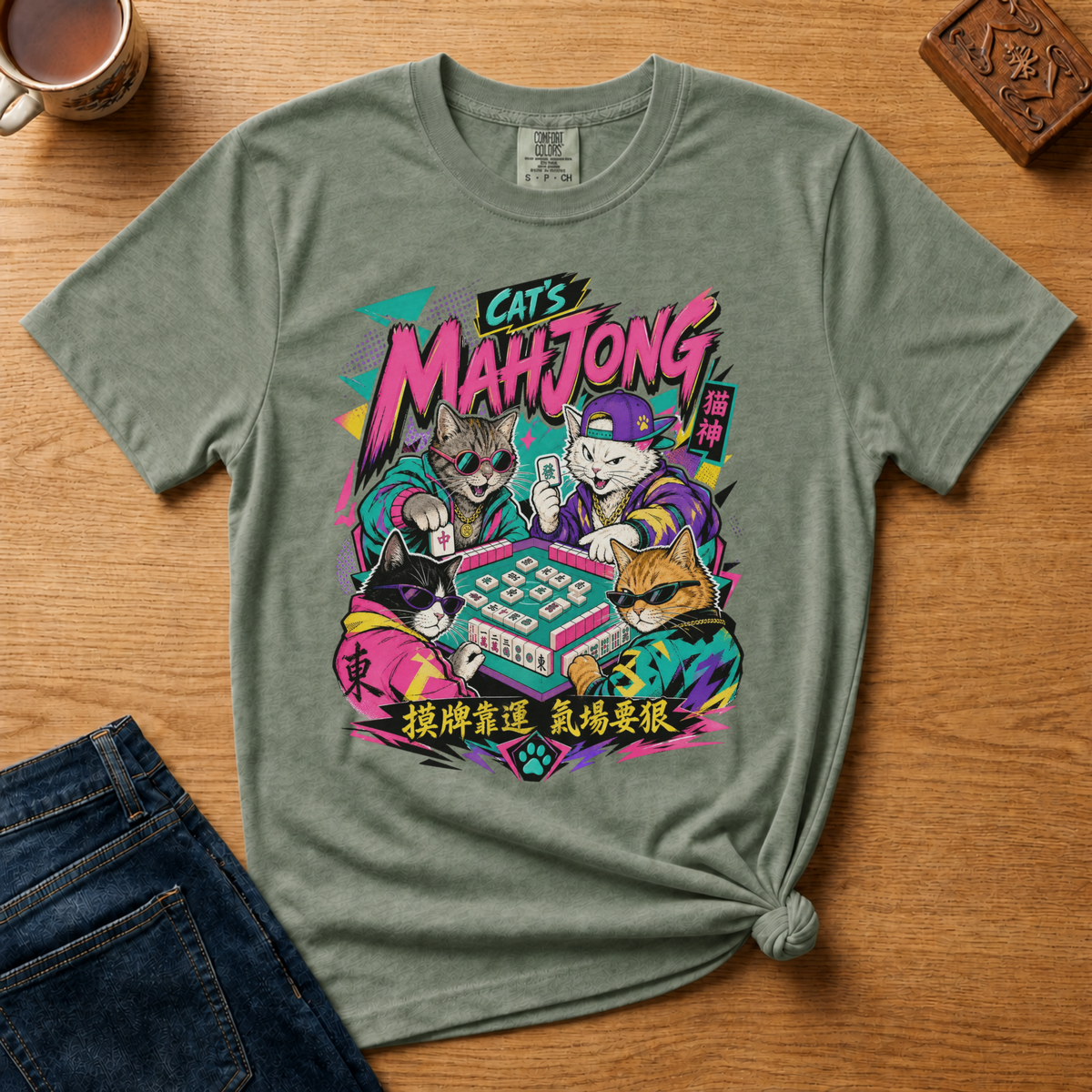 Retro 90s Mahjong Cats Shirt in Jean Blue - four streetwear cats playing mahjong in retro anime style on a blue Comfort Colors 1717 tee, flat lay