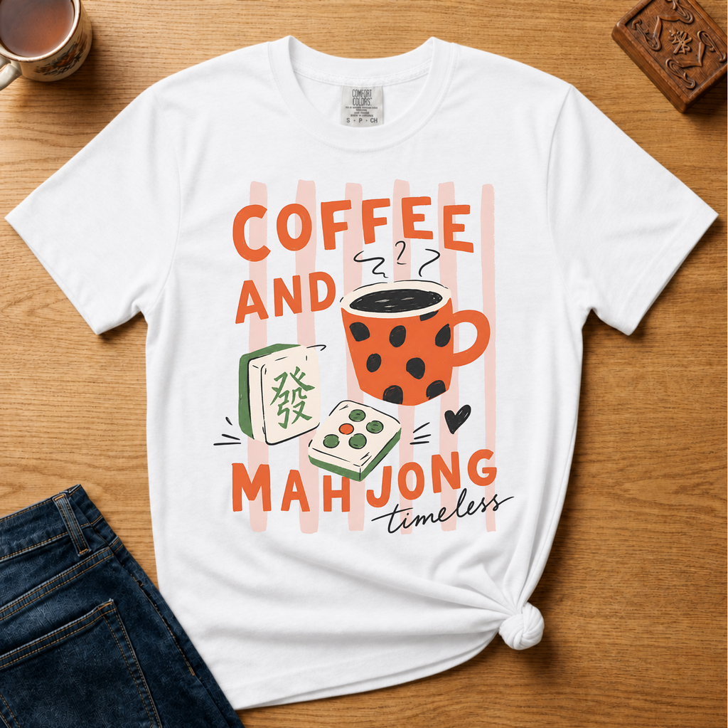 Striped Coffee and Mahjong Shirt in Blossom - orange lettering with polka-dot mug and tiles over pink stripes on a pink Comfort Colors 1717 tee, flat lay