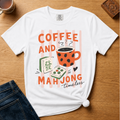 Striped Coffee and Mahjong Shirt in Blossom - orange lettering with polka-dot mug and tiles over pink stripes on a pink Comfort Colors 1717 tee, flat lay