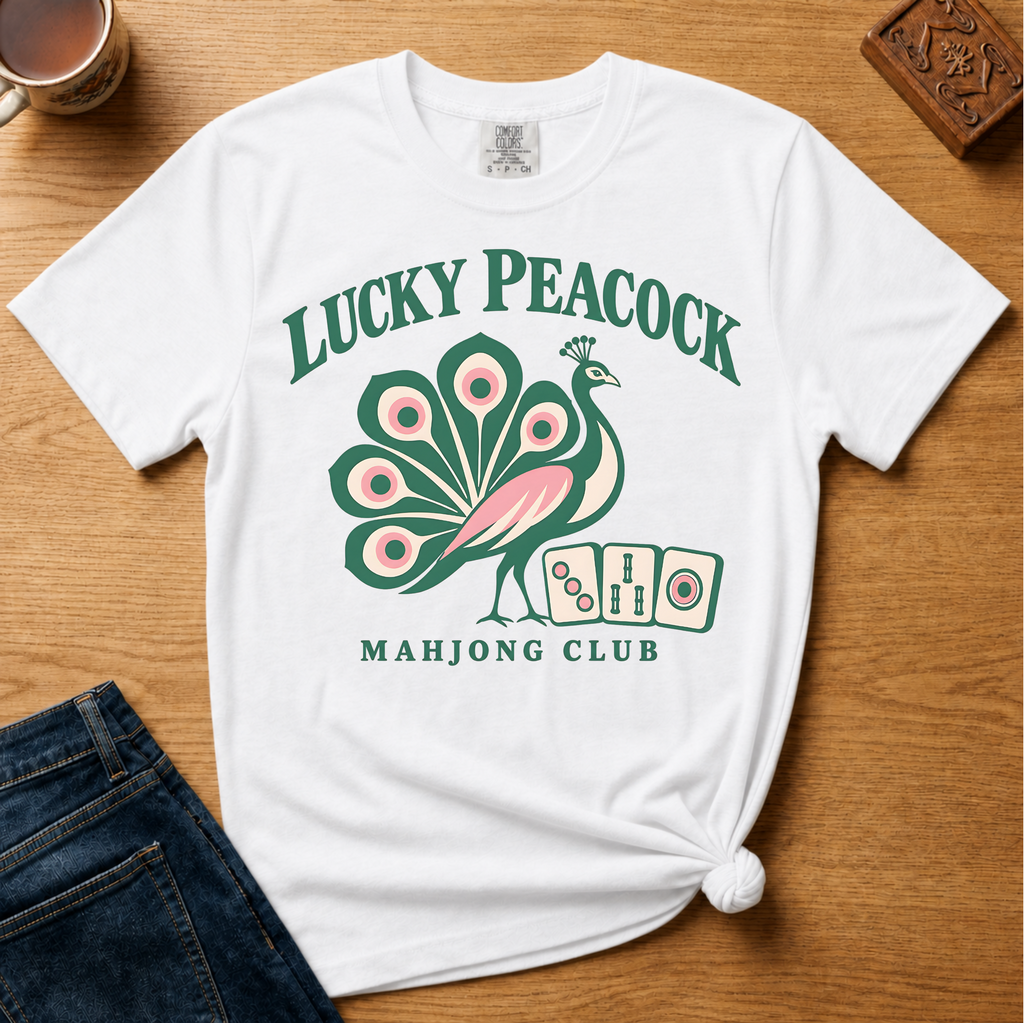 Lucky Peacock Mahjong Shirt in Blossom - green and pink peacock with mahjong tiles on a pink Comfort Colors 1717 tee, flat lay