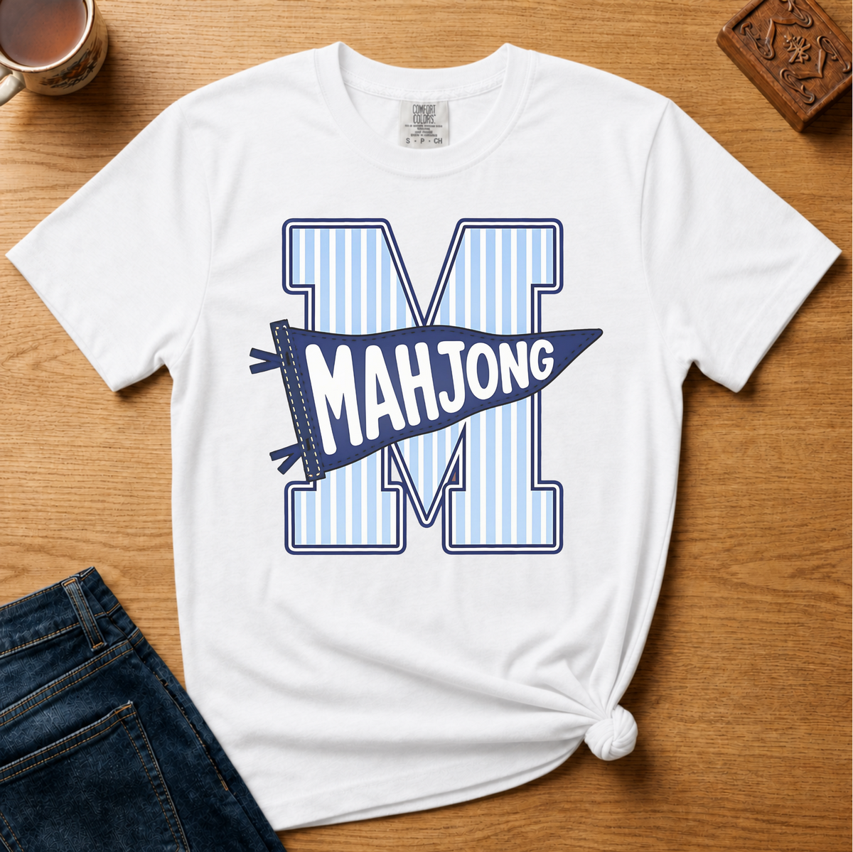 Mahjong Pennant Shirt in Blossom - giant striped varsity M with navy MAHJONG pennant banner on a pink Comfort Colors 1717 tee, flat lay