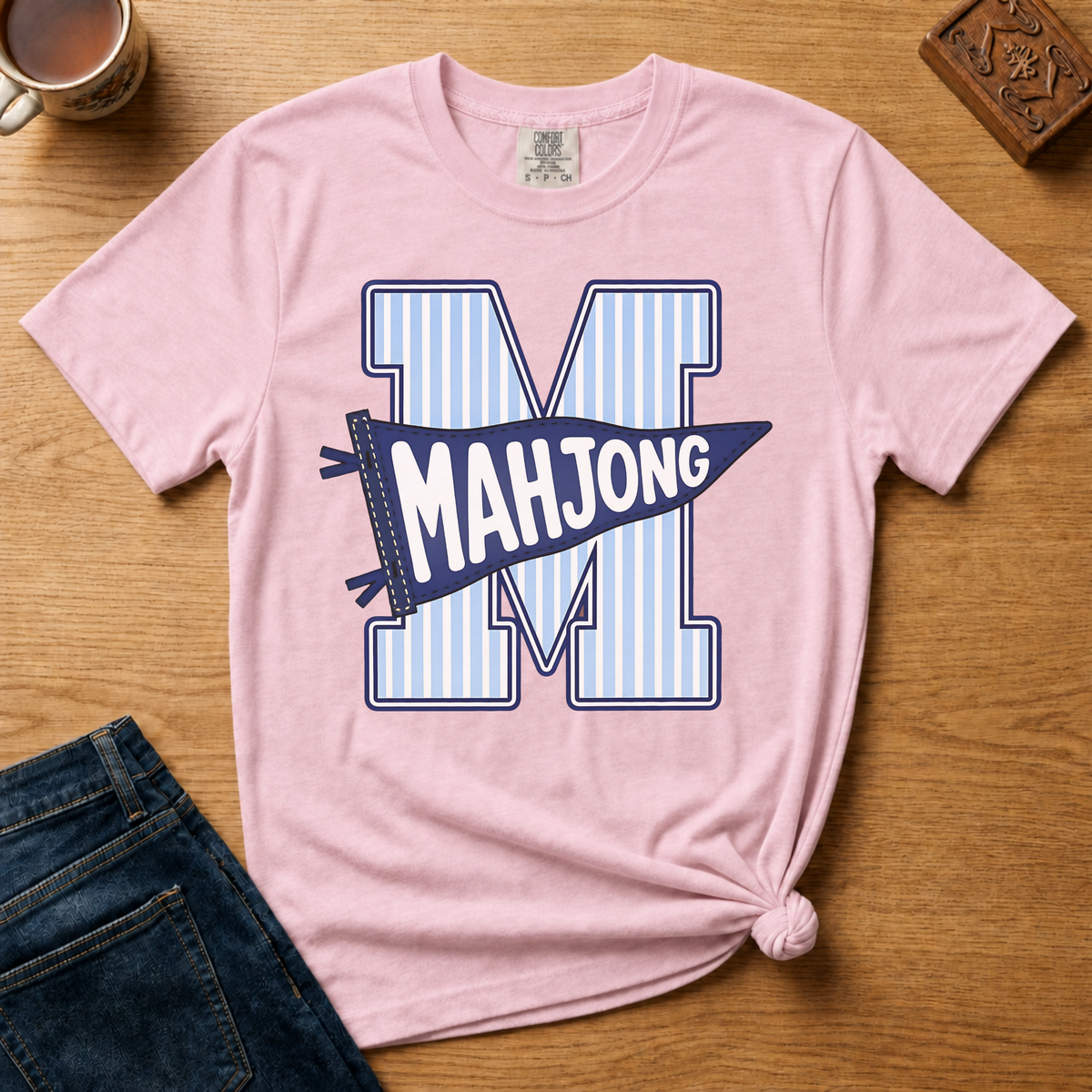 Mahjong Pennant Shirt in Ivory - giant striped varsity M with navy MAHJONG pennant banner on an ivory Comfort Colors 1717 tee, flat lay