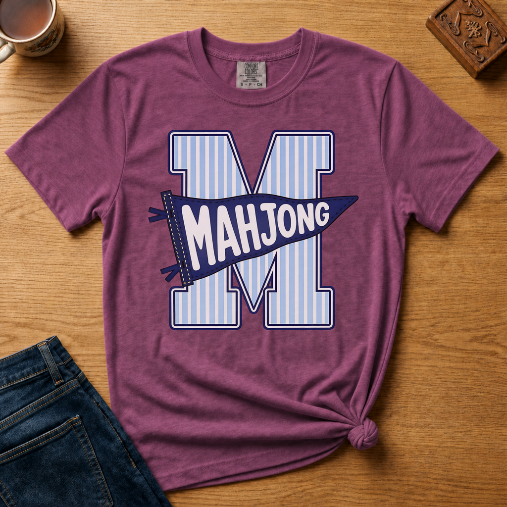 Mahjong Pennant Shirt in Moss - giant striped varsity M with navy MAHJONG pennant banner on a green Comfort Colors 1717 tee, flat lay