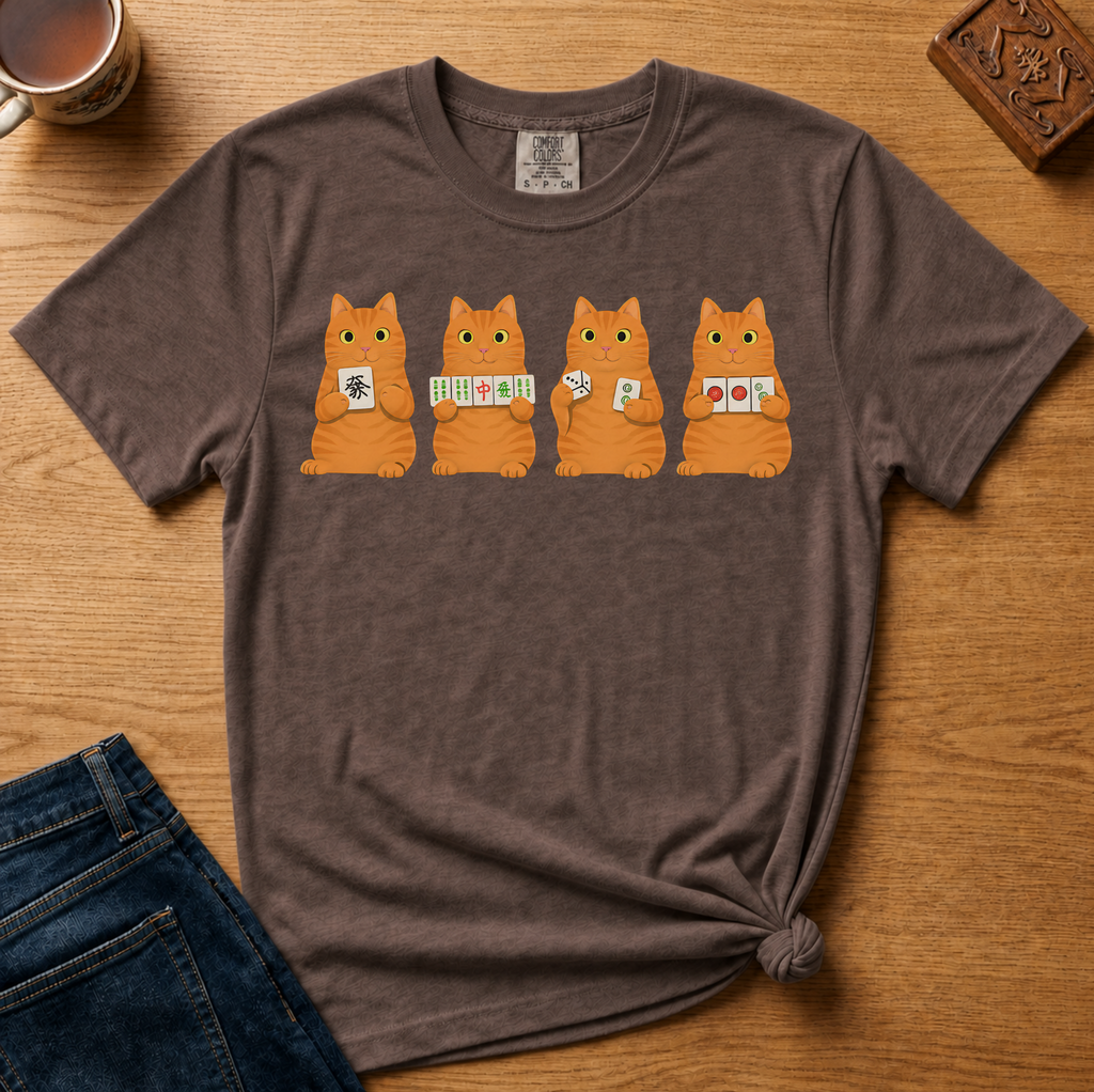 Mahjong Orange Tabby Cats Shirt in Ivory - four orange tabby cats holding mahjong tiles on an ivory Comfort Colors 1717 tee, flat lay