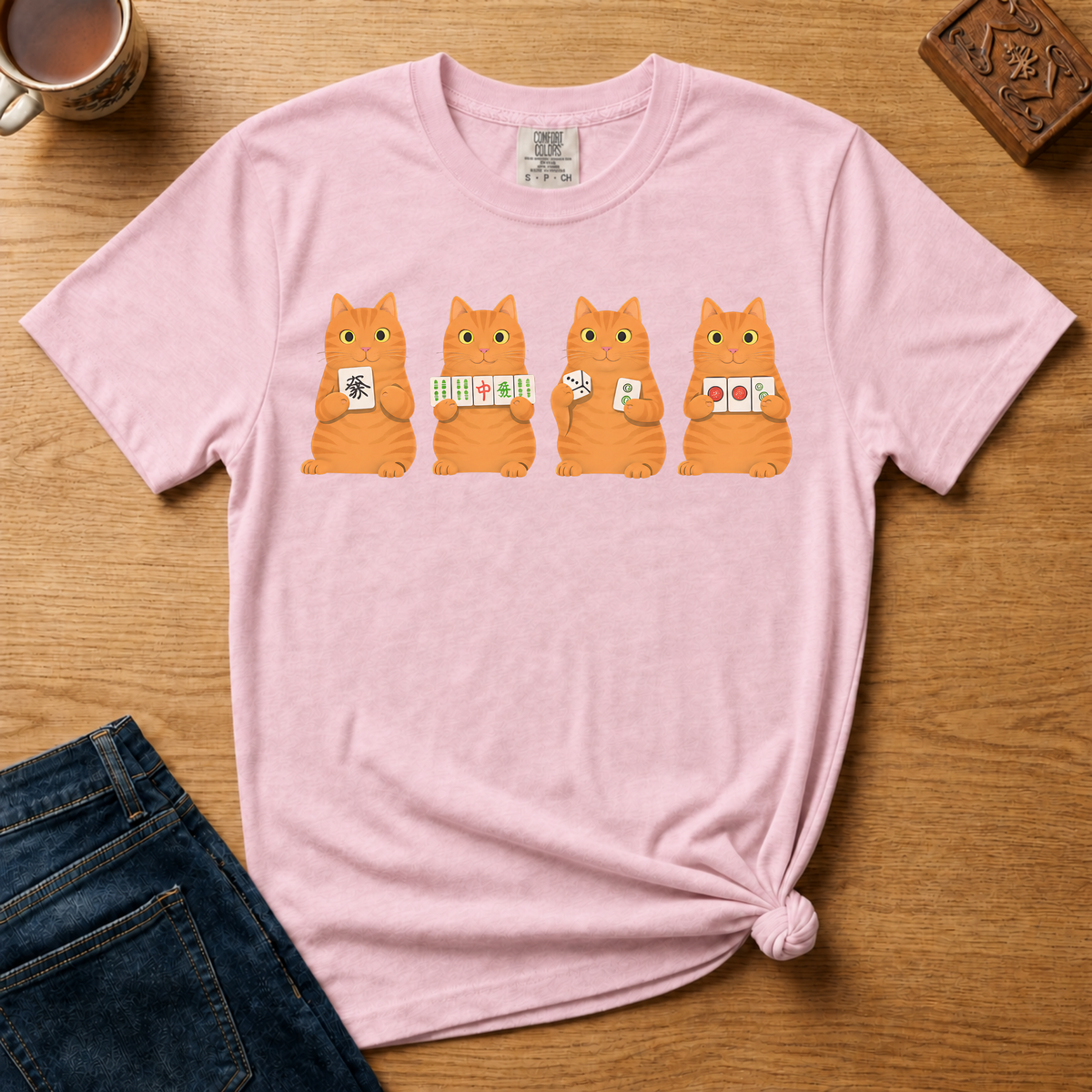 Mahjong Orange Tabby Cats Shirt in Espresso - four orange tabby cats holding mahjong tiles on a brown Comfort Colors 1717 tee, flat lay