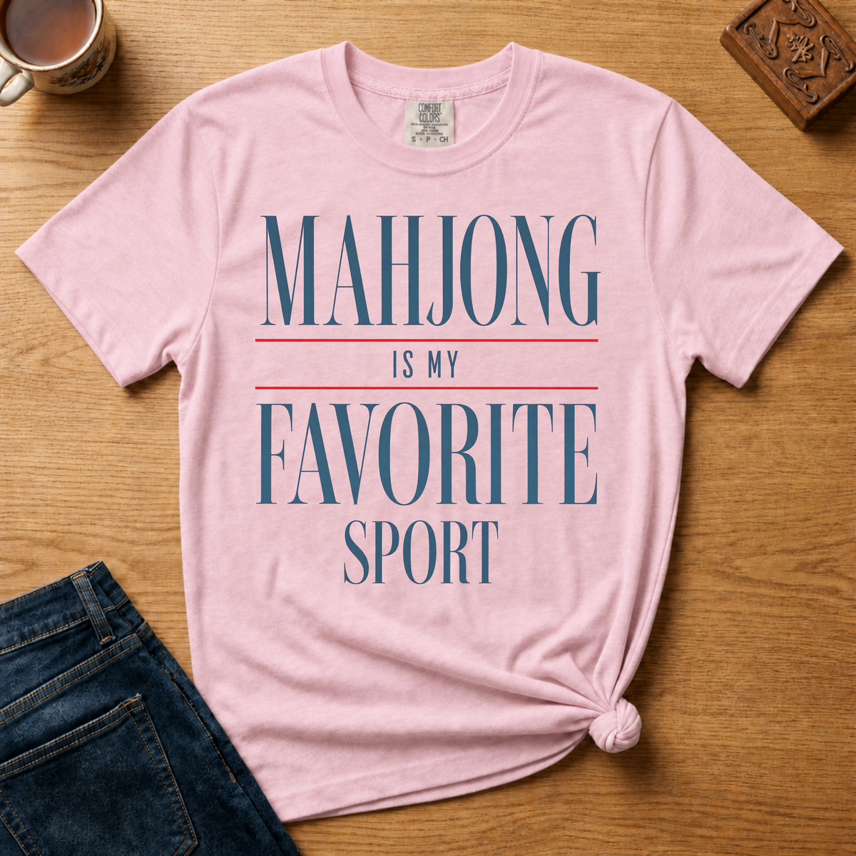 Mahjong Is My Favorite Sport Shirt in Violet - navy serif lettering with red divider lines on a purple Comfort Colors 1717 tee, flat lay