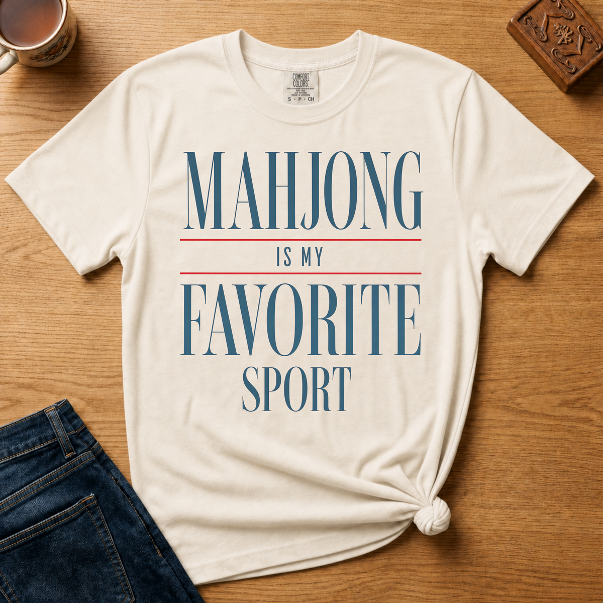 Mahjong Is My Favorite Sport Shirt in Ivory - navy serif lettering with red divider lines on an ivory Comfort Colors 1717 tee, flat lay