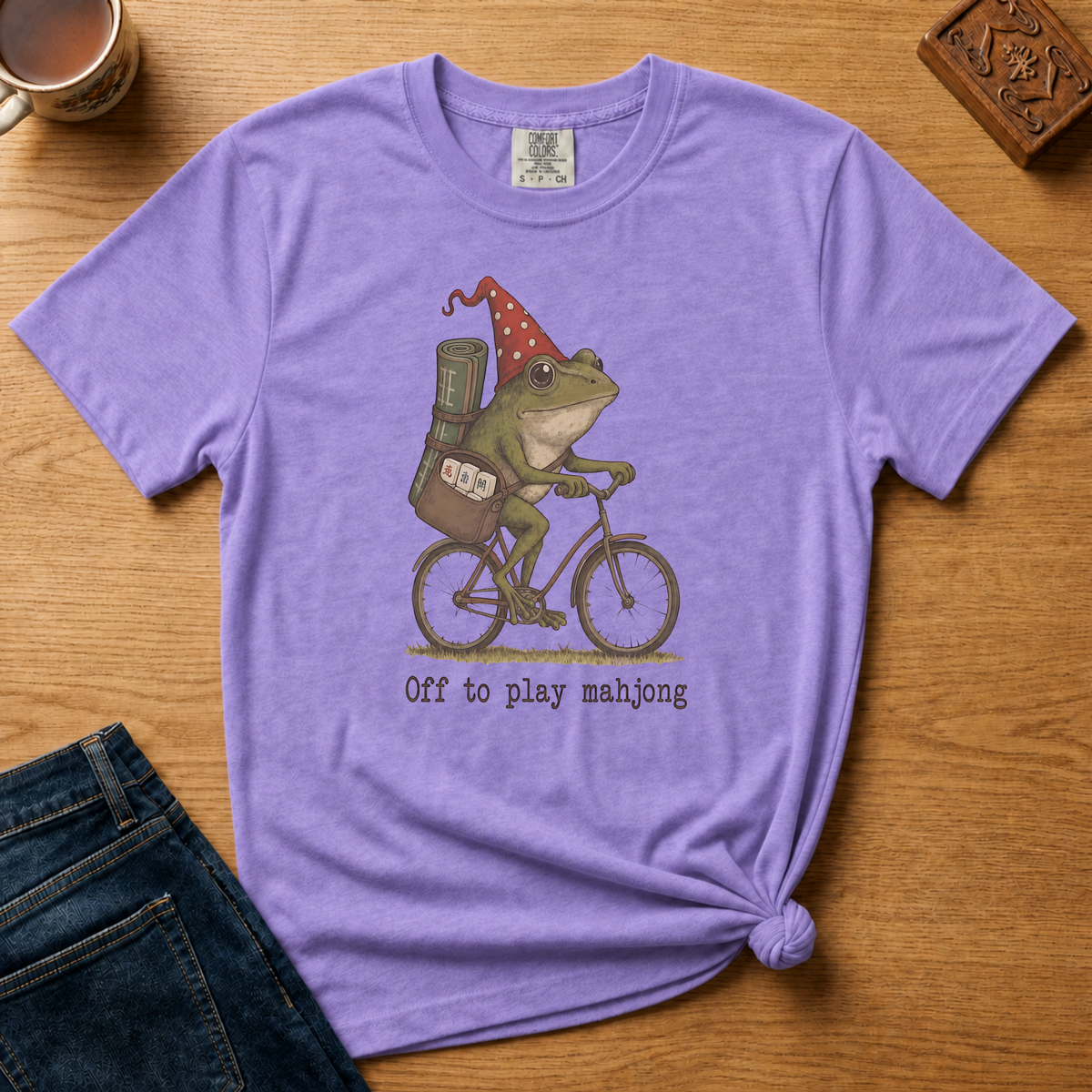 Close-up of the Off To Play Mahjong design - frog on a bicycle with his tiles