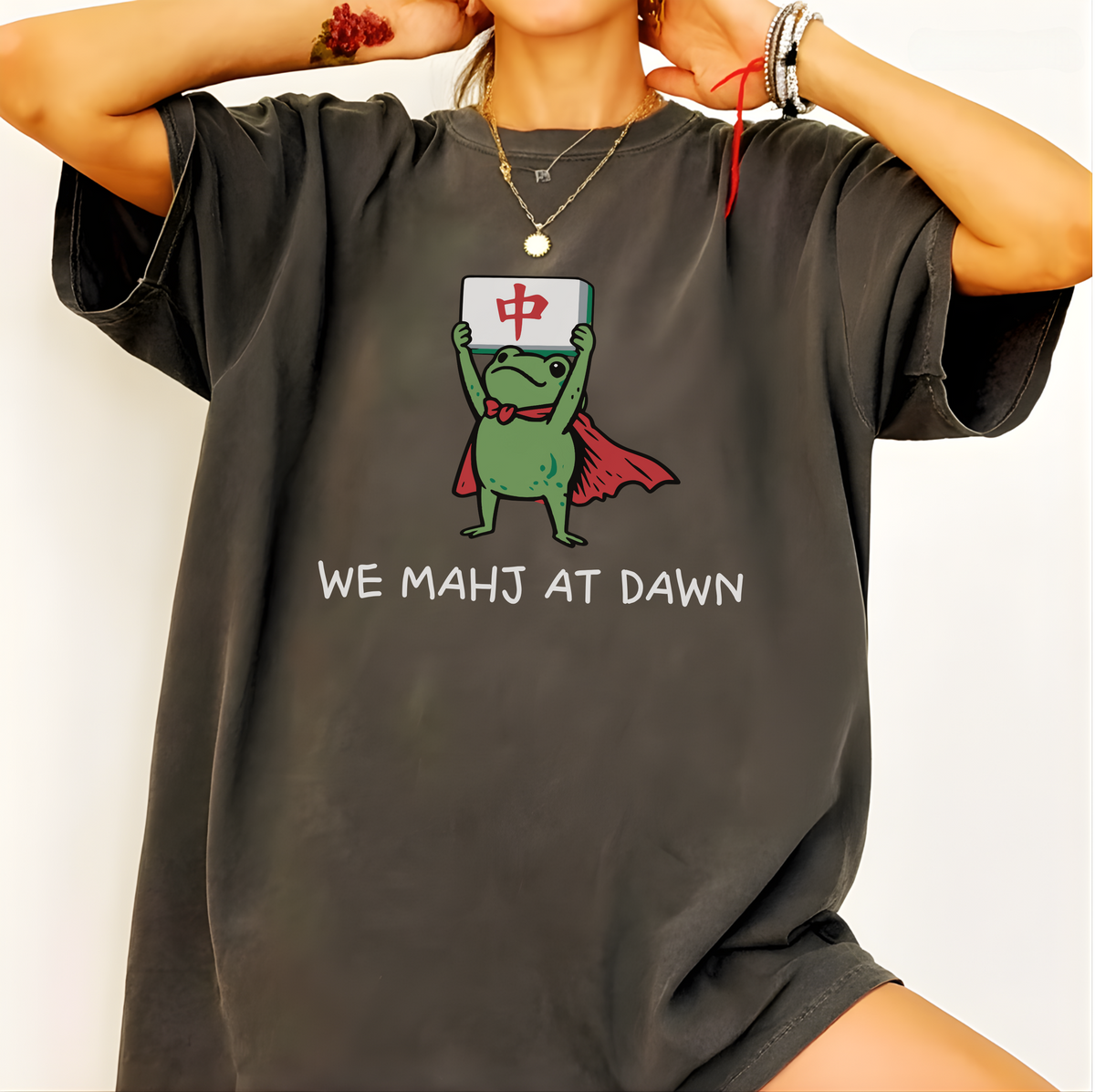 Close-up of the We Mahj At Dawn design - caped frog holding his red dragon tile
