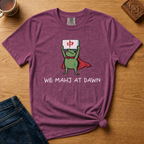 We Mahj At Dawn Shirt in Moss - superhero frog in a red cape holding a red dragon tile overhead on a green Comfort Colors 1717 tee, flat lay