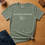 It's About Bam Time Shirt in Jean Blue - white typewriter text with a green dragon tile pair on a slate blue Comfort Colors 1717 tee, flat lay