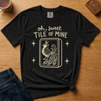 Oh Sweet Tile Of Mine Shirt in Moss - cream oh sweet tile of mine lettering with a crowned peacock tile on a green Comfort Colors 1717 tee, flat lay