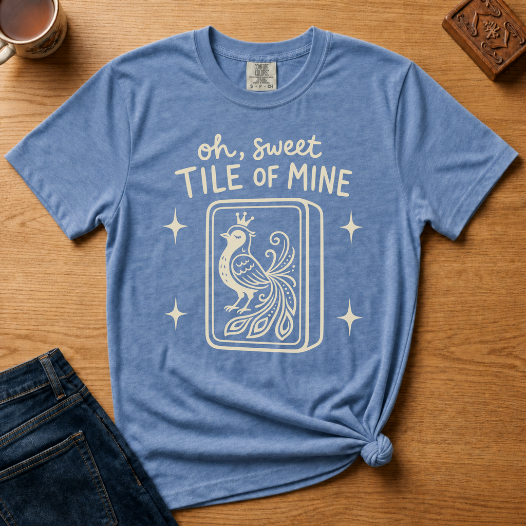 Oh Sweet Tile Of Mine Shirt in Black - cream oh sweet tile of mine lettering with a crowned peacock tile on a black Comfort Colors 1717 tee, flat lay