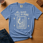 Oh Sweet Tile Of Mine Shirt in Black - cream oh sweet tile of mine lettering with a crowned peacock tile on a black Comfort Colors 1717 tee, flat lay