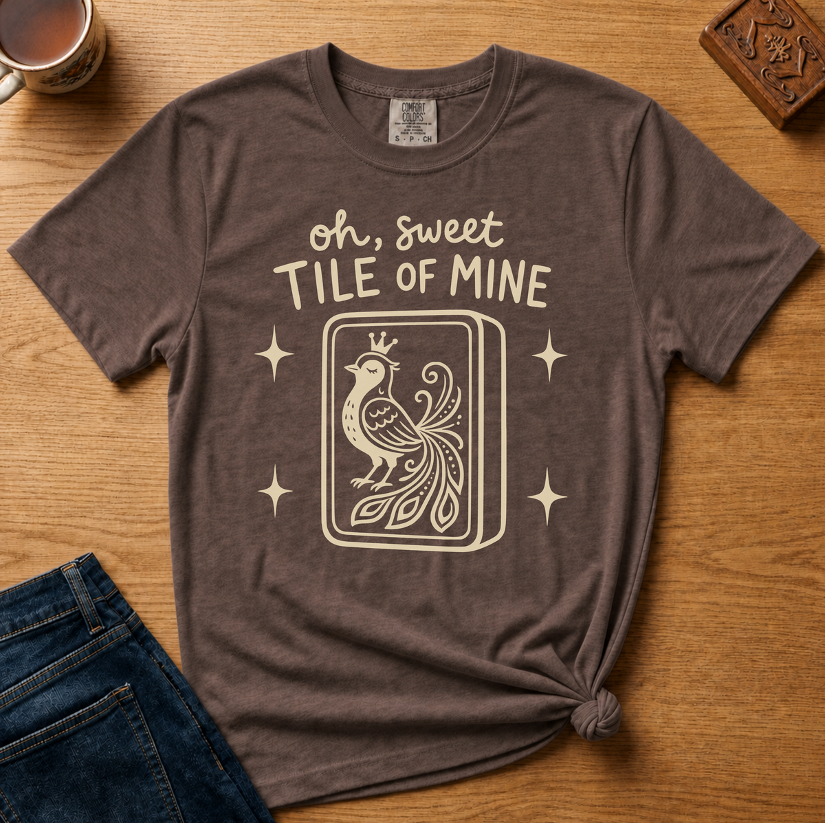 Oh Sweet Tile Of Mine Shirt in Berry - cream oh sweet tile of mine lettering with a crowned peacock tile on a berry Comfort Colors 1717 tee, flat lay