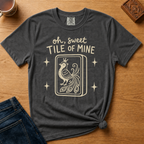 Oh Sweet Tile Of Mine Shirt in Pepper - cream oh sweet tile of mine lettering with a crowned peacock tile on a dark grey Comfort Colors 1717 tee, flat lay