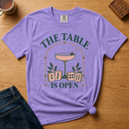 The Table Is Open Shirt in White - close-up of the cocktail coupe, peach tiles and THE TABLE IS OPEN lettering