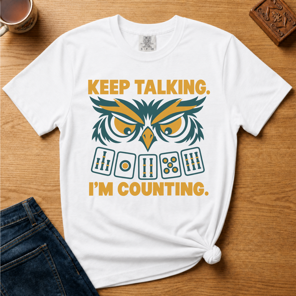 Close-up of the Keep Talking, I'm Counting owl design on a White Comfort Colors t-shirt.