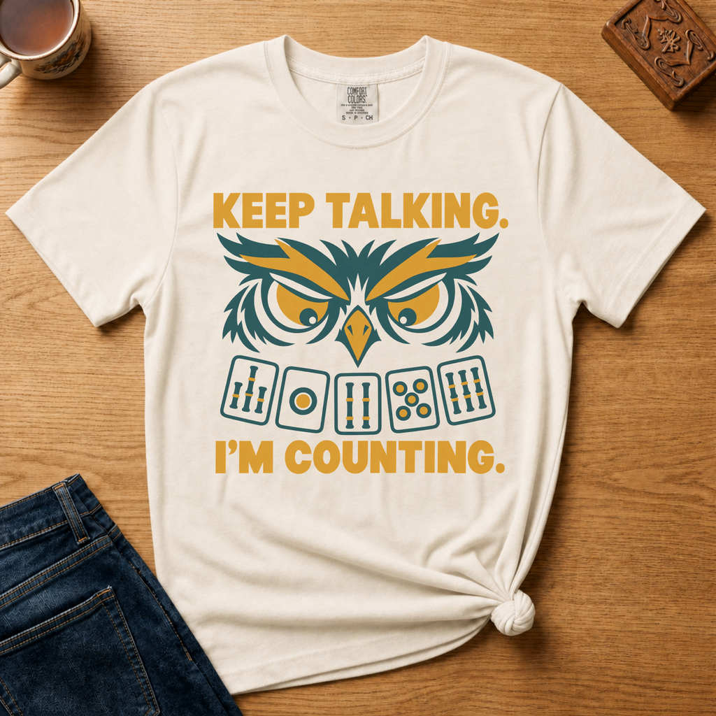 Close-up of the Keep Talking, I'm Counting owl design on a Moss Comfort Colors t-shirt.