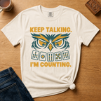Close-up of the Keep Talking, I'm Counting owl design on a Moss Comfort Colors t-shirt.