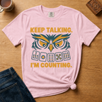 Close-up of the Keep Talking, I'm Counting owl design on an Ivory Comfort Colors t-shirt.