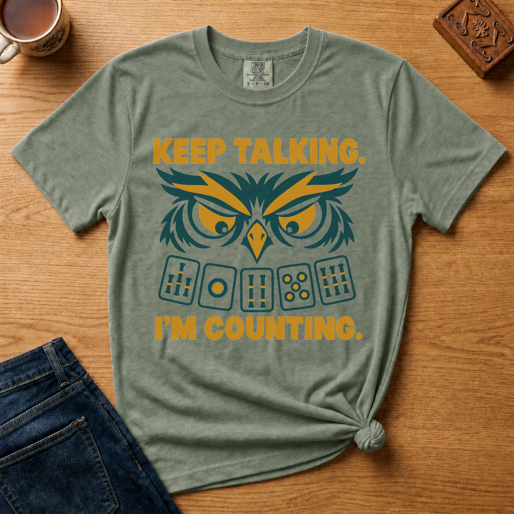Keep Talking, I'm Counting owl mahjong shirt in Ivory, styled flat lay on a wooden table with jeans and coffee.