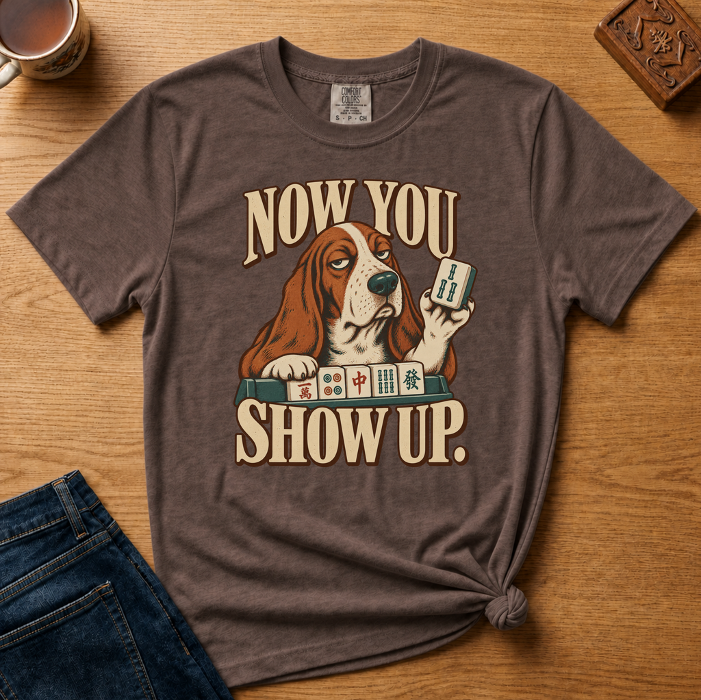 Close-up of the Now You Show Up basset hound design on a Jean Blue Comfort Colors t-shirt.
