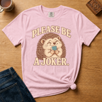 Close-up of the Please Be A Joker hedgehog design on a White Comfort Colors t-shirt.