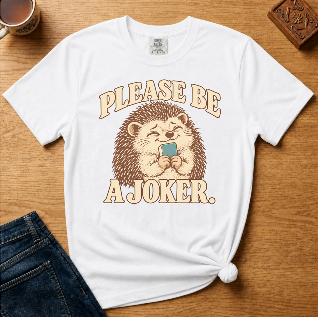 Close-up of the Please Be A Joker hedgehog design on a Moss Comfort Colors t-shirt.