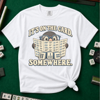 It's On The Card Somewhere mahjong shirt in Berry — a wide-eyed mole in oversized glasses peeking over the open mahjong card, three tiles below, with the words IT'S ON THE CARD. SOMEWHERE.