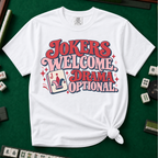 Jokers Welcome Drama Optional T-Shirt in Black - knotted tee on a light surface with mahjong tiles scattered around, printed with the words Jokers Welcome Drama Optional in retro bubble lettering with a joker tile