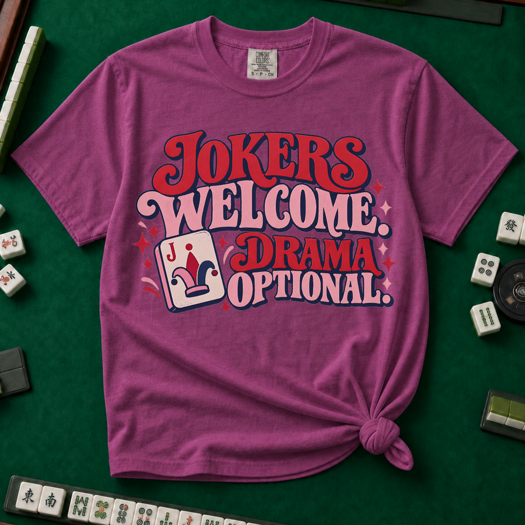 Jokers Welcome Drama Optional T-Shirt in White - knotted tee on a green mahjong mat with scattered tiles, printed with the words Jokers Welcome Drama Optional in retro bubble lettering with a joker tile