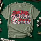 Jokers Welcome Drama Optional T-Shirt in Berry - knotted tee on a green mahjong mat with scattered tiles, printed with the words Jokers Welcome Drama Optional in retro bubble lettering with a joker tile